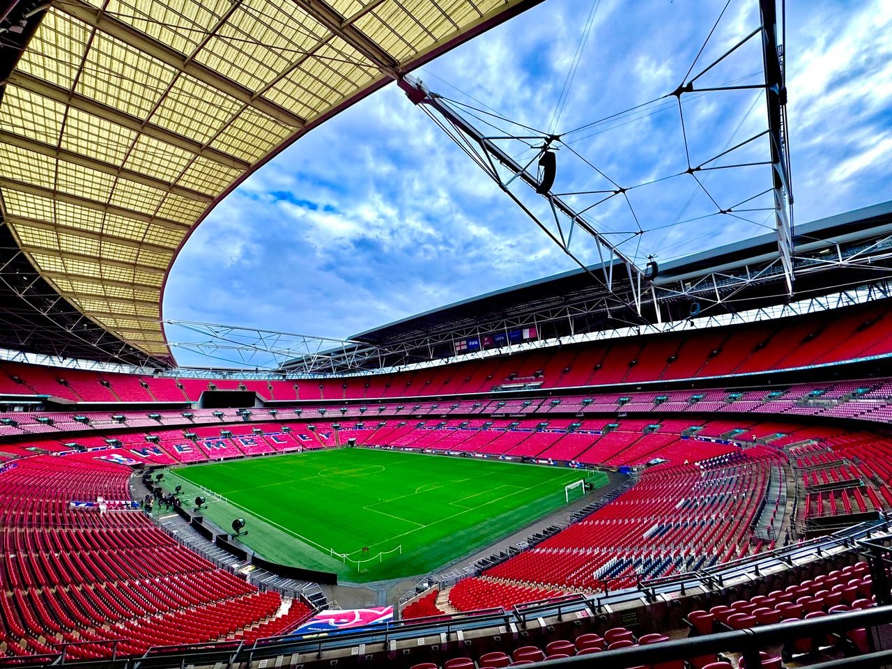 A stunning view of the iconic Wembley Stadium in London, capturing its vastness and architectural beauty.